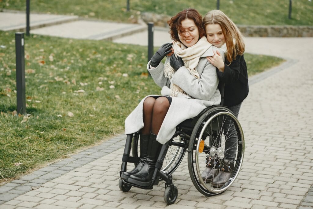 A disabled person in a wheelchair using a sidewalk, highlighting the importance of accessibility and the need for professional ADA compliant sidewalk work.